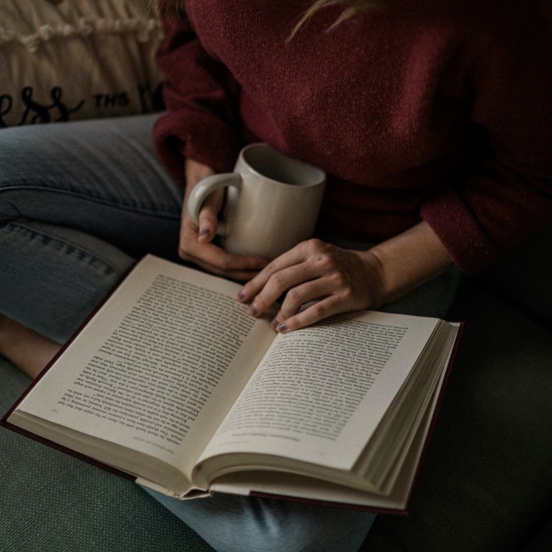 Image of woman reading a books for The Archive, a bookstore and coffee shop in Charleston, South Carolina.