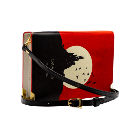 Book-shaped handbag with red cover and black silhouette design on a white background