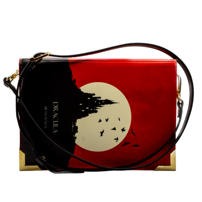 Red handbag with black strap and tree design on a white background