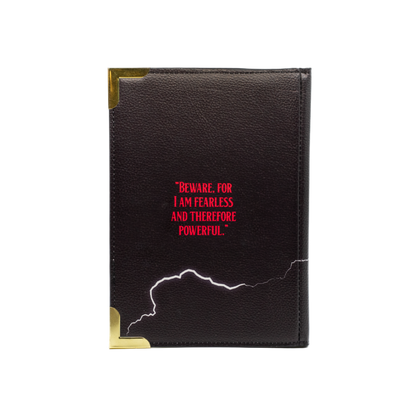 Black leather notebook with red text and gold accents on a white background