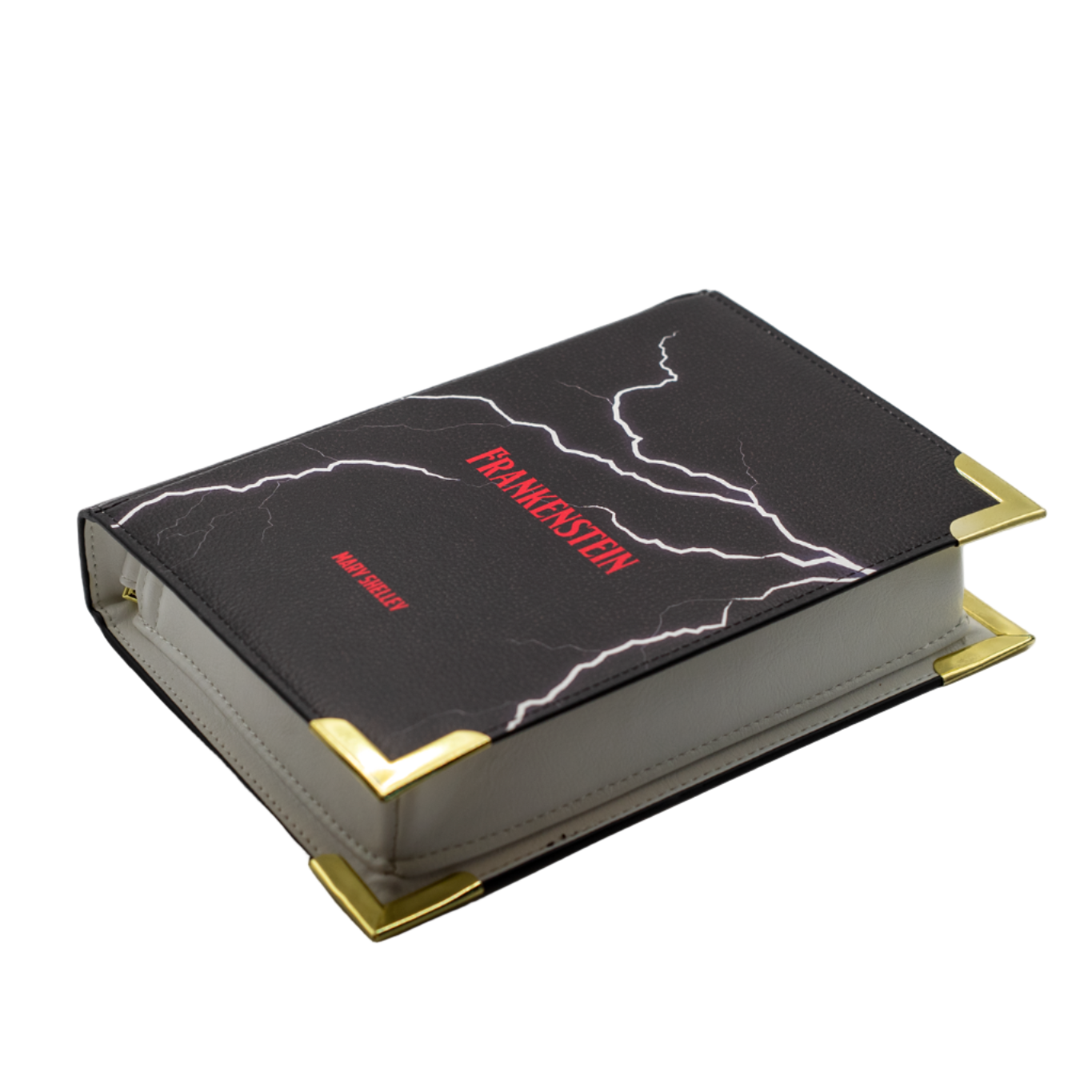 Black book with gold edges and red text on a white background