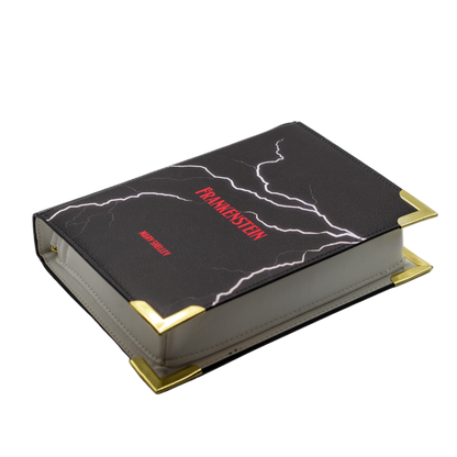 Black book with gold edges and red text on a white background