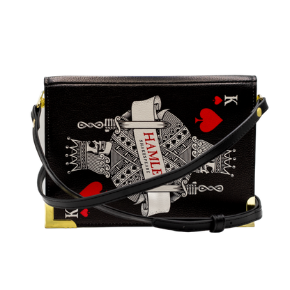 Black handbag with playing card design on a white background