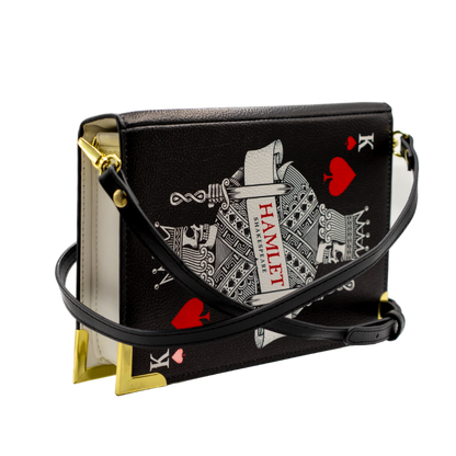 Black handbag with playing card design on a white background