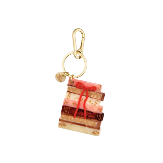 Keychain with a design of books and a red ribbon on a white background