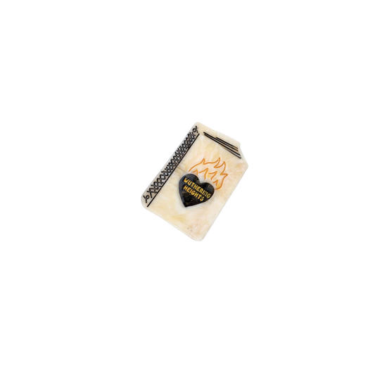 Decorative hair clip with heart design and text on a white background