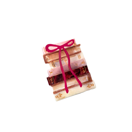 Set of books tied with a pink ribbon on a white background