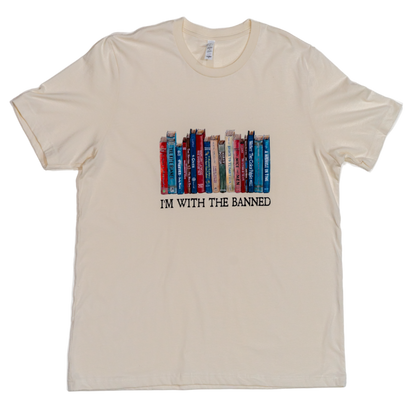 Beige t-shirt with book graphic and text 'I'm with the banned' on a white background
