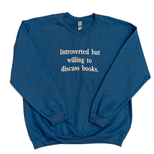 Blue sweatshirt with text 'Introverted but willing to discuss books' on a white background