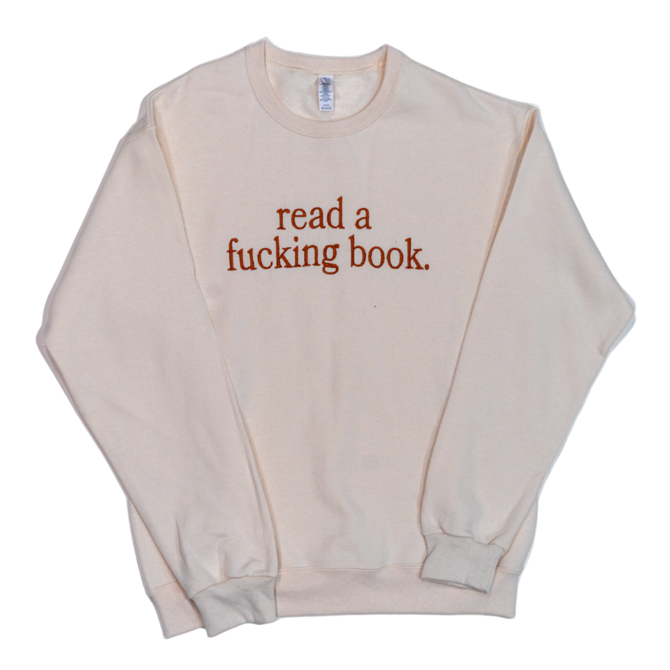 Beige sweatshirt with text 'read a fucking book' on a white background