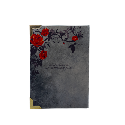 Decorative notebook with red roses and black leaves on a gray background