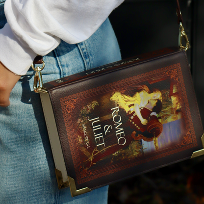 Handbag designed like a book titled 'Romeo & Juliet' held by a person.