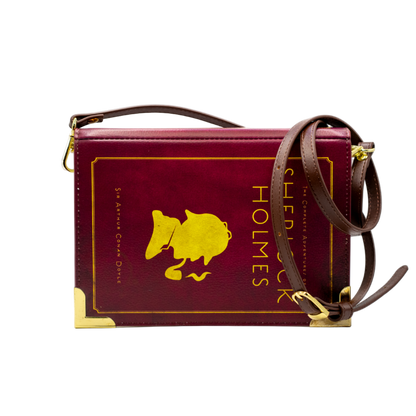 Maroon book-shaped handbag with gold accents and 'Sherlock Holmes' text on a white background