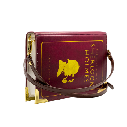 Burgundy book-shaped handbag with Sherlock Holmes logo on a white background