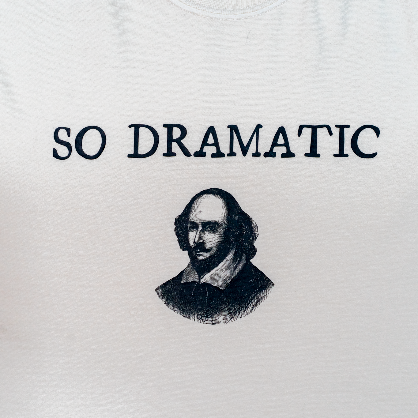 White shirt with Shakespeare illustration and 'SO DRAMATIC' text on a white background