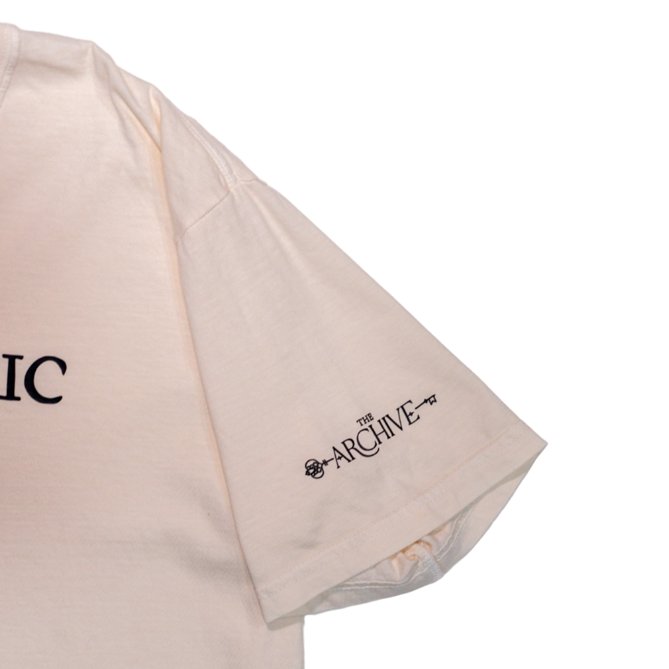 Beige t-shirt with 'The Archive' branding on a white background