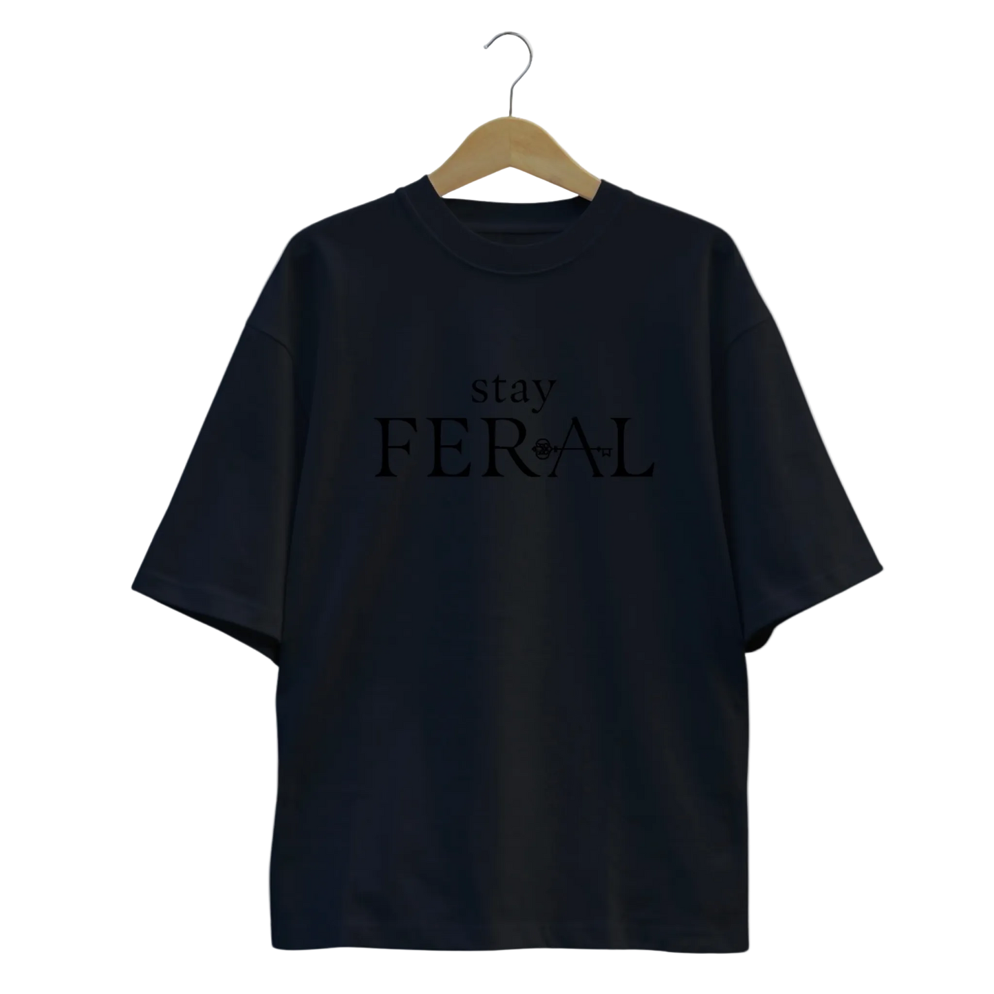 Black t-shirt with 'stay FERAL' text on a hanger against a white background