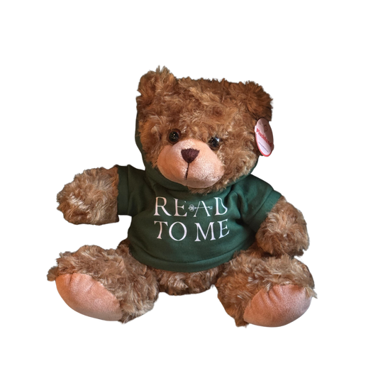 Teddy bear wearing a green shirt with 'READ TO ME' text on a white background