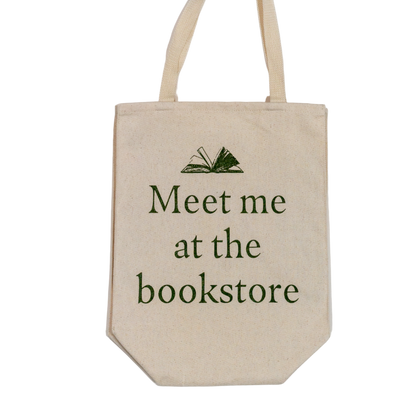 Beige tote bag with 'Meet me at the bookstore' text on a white background